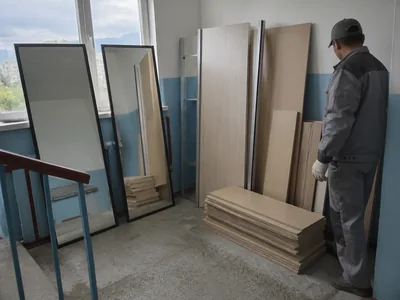 A sliding-door wardrobe with mirrored doors, dismantled before removal