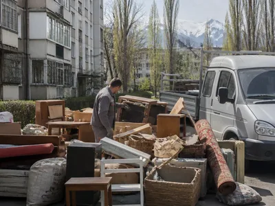 A mixed pile of old furniture and household junk in the yard