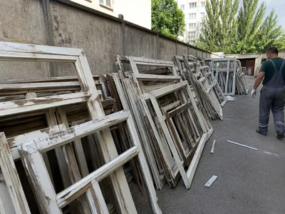 Old window frames after dismantling, stacked by the wall